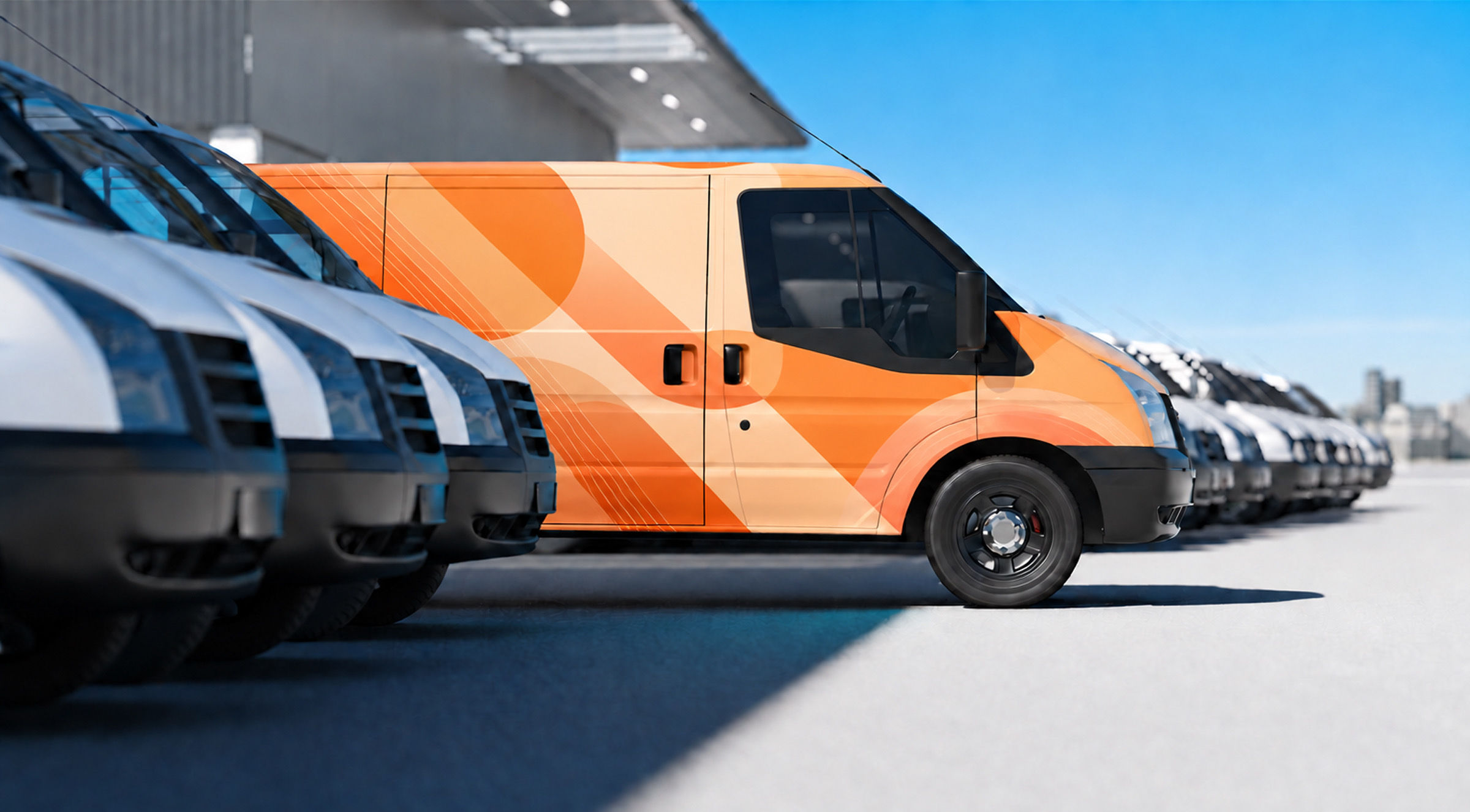 A delivery van wrapped in full graphics, parked in a row of vans
